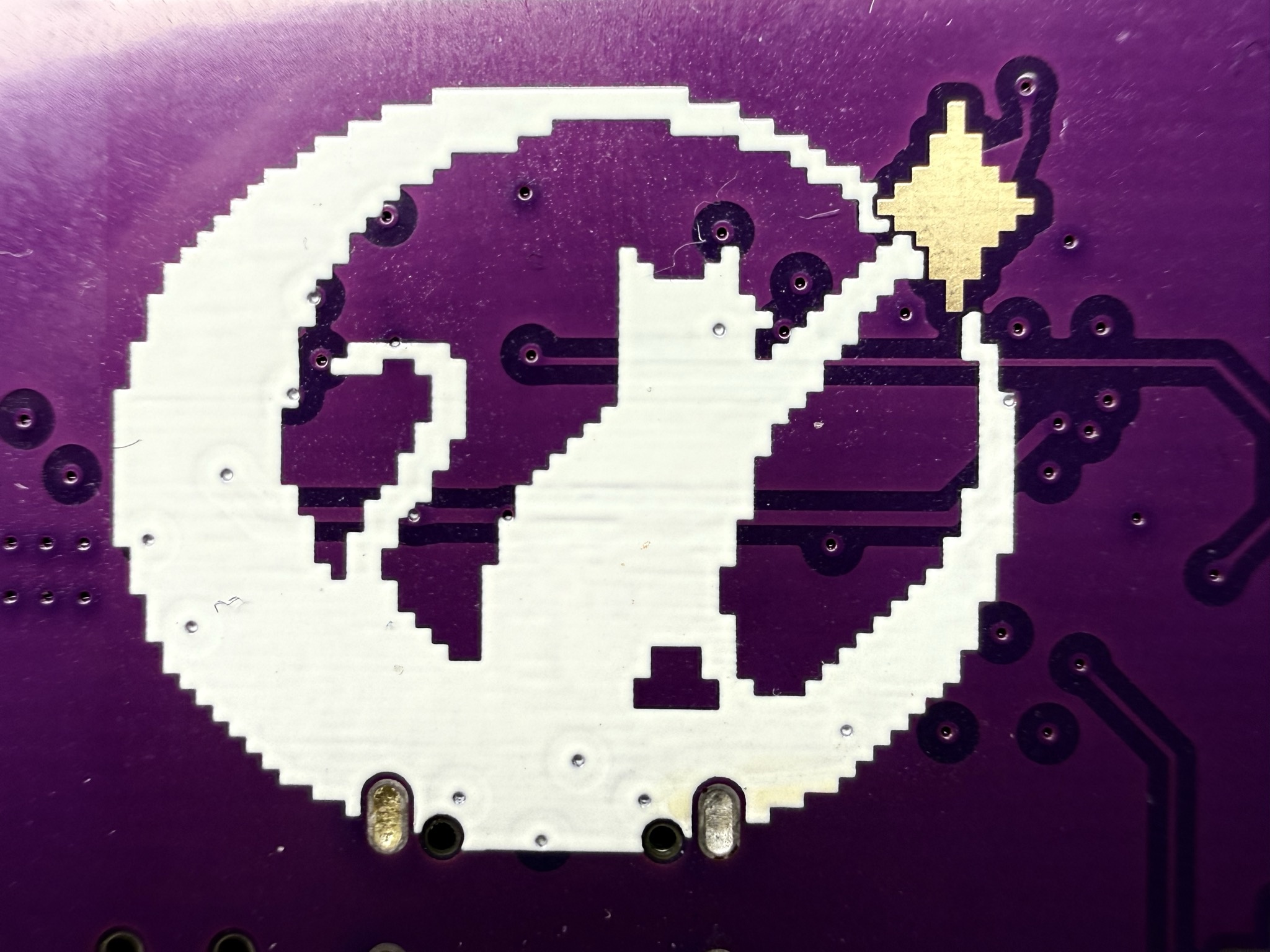 Cat on crescent moon touching ENIG gold star capacitive pad on WICCON badge